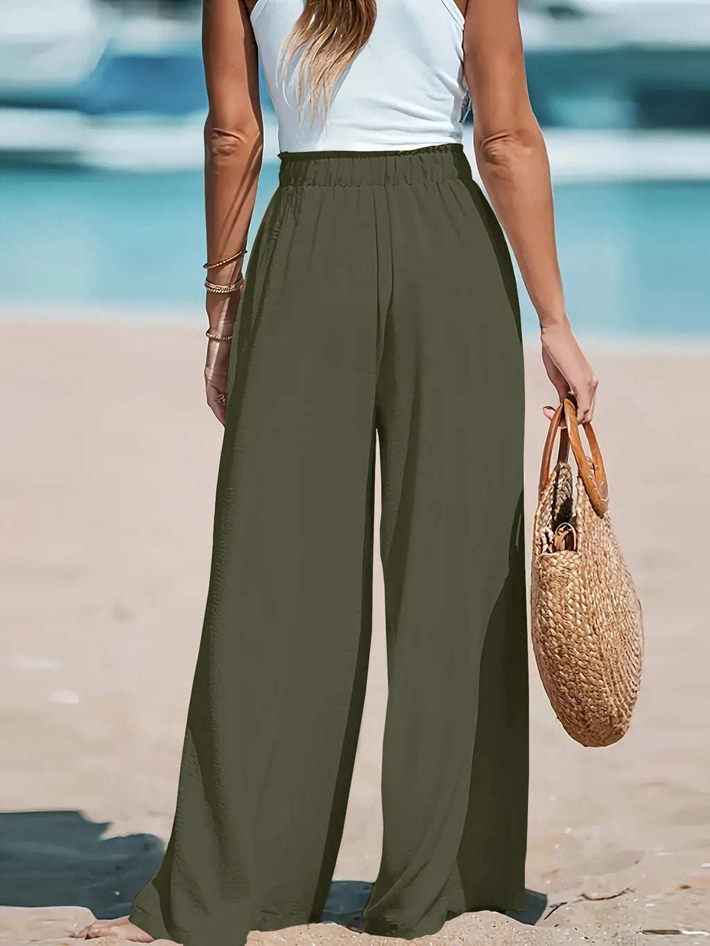 Close up shot of the smooth, non-see-through premium polyester fabric showing its fluid movement on CLOTHRA matching pants. Back side view in a color Army Green