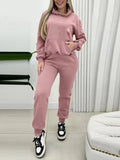CLOTHRA matching long sleeve pullover hoodie and tapered joggers two piece lounge set in a clean minimalist street look. Front View