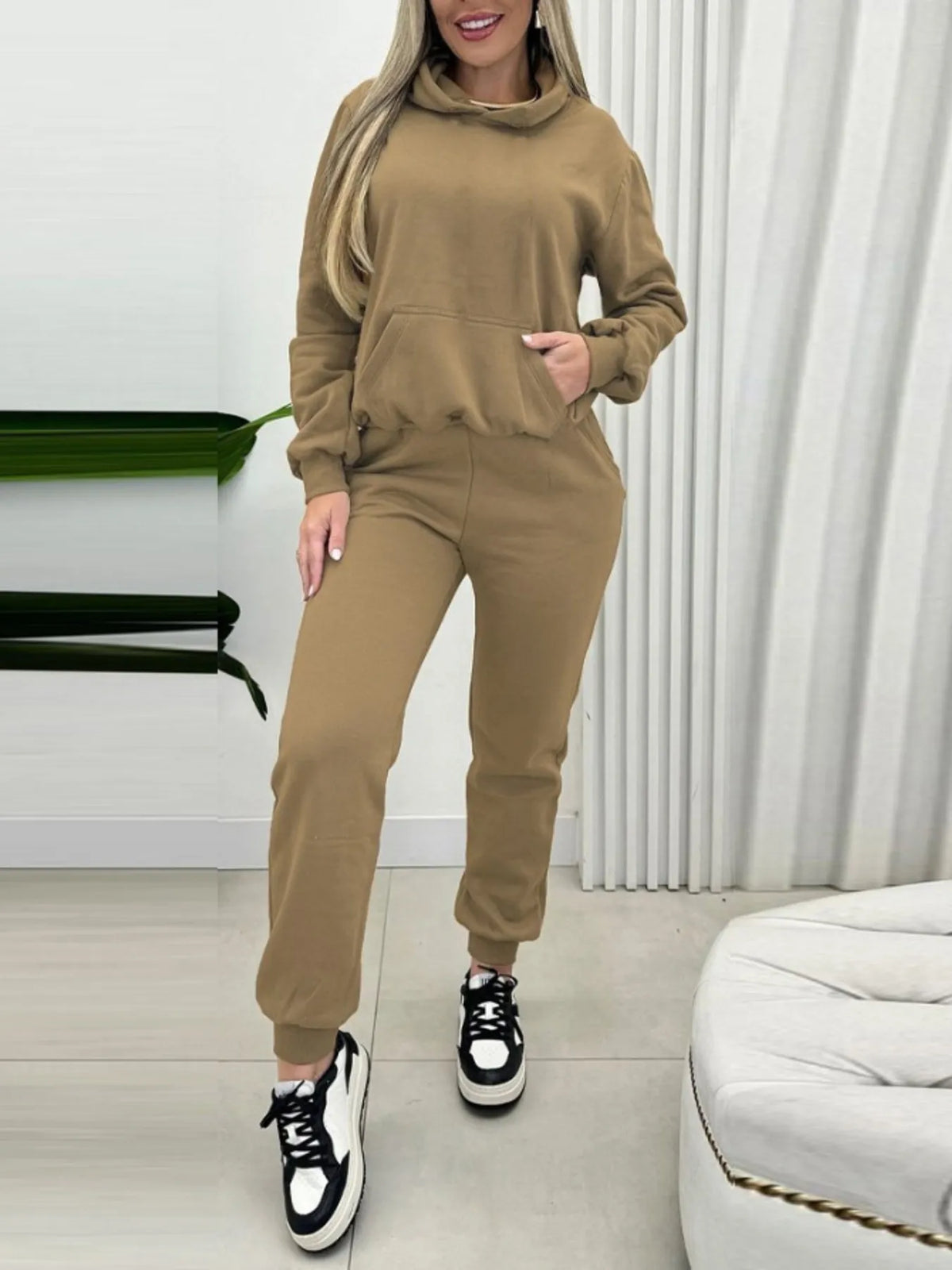 CLOTHRA matching long sleeve pullover hoodie and tapered joggers two piece lounge set in a clean minimalist street look. Full view