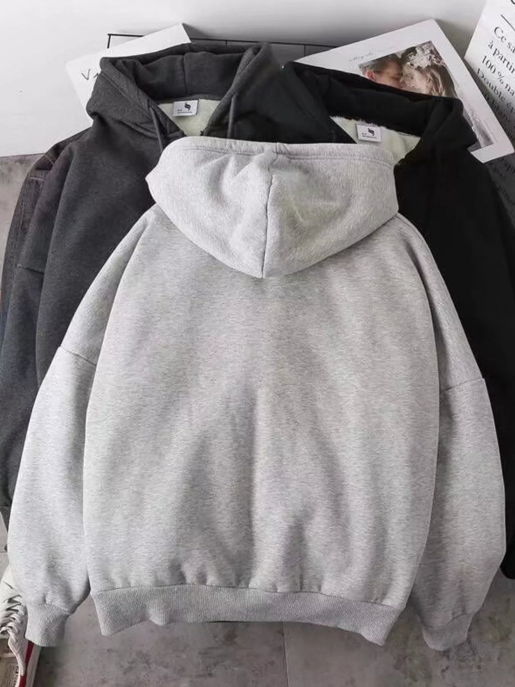 Close up of the warm plush fleece lining interior and smooth metal zipper track on CLOTHRA plus size unisex hoodie Back side view