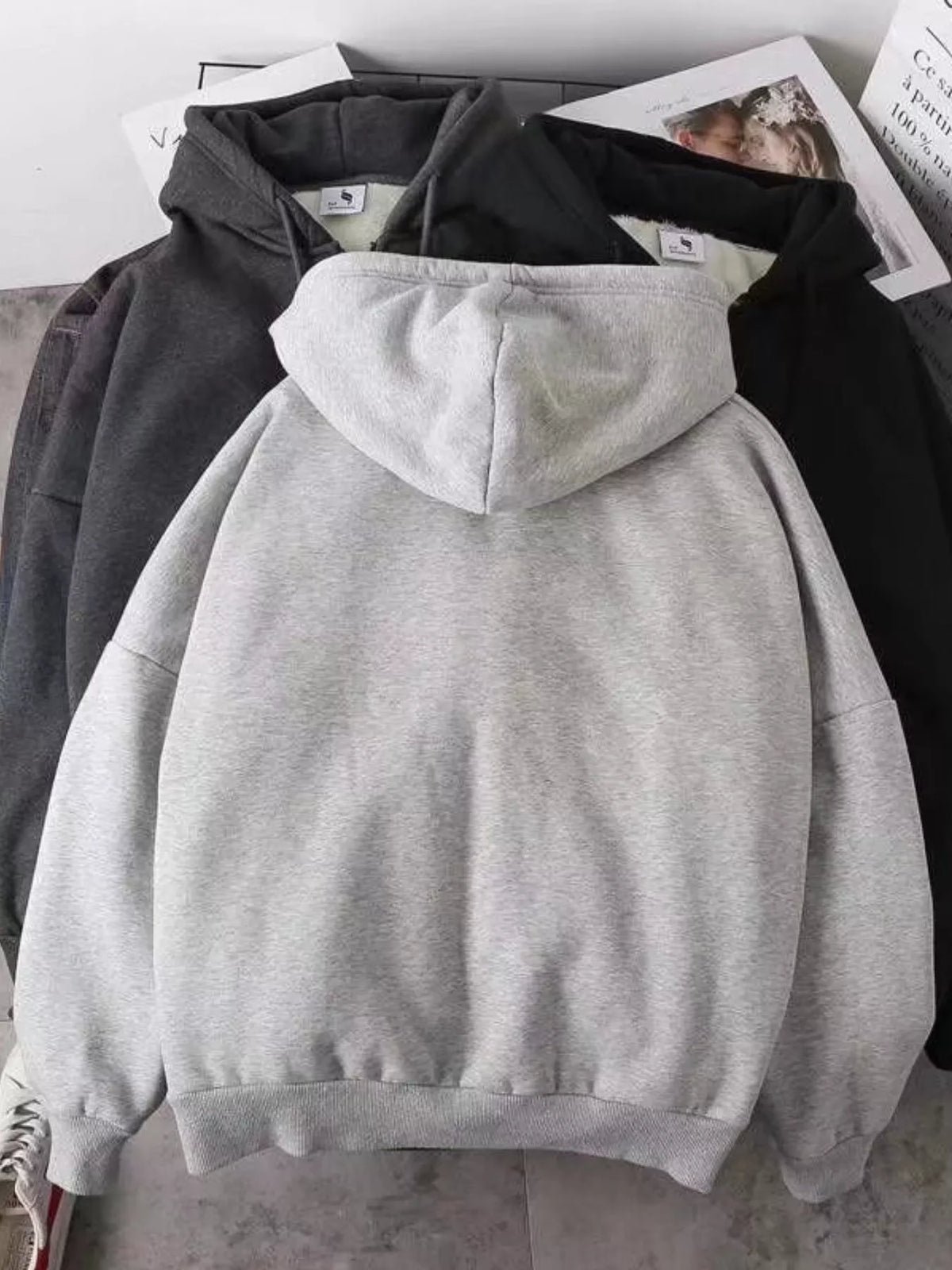 Close up of the warm plush fleece lining interior and smooth metal zipper track on CLOTHRA plus size unisex hoodie Back side view
