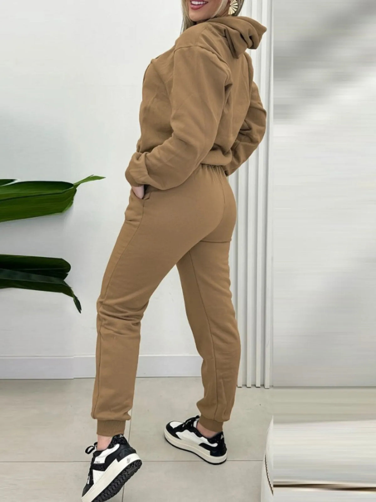 CLOTHRA matching long sleeve pullover hoodie and tapered joggers two piece lounge set in a clean minimalist street look. Side view Khaki