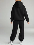 CLOTHRA plus size matching pullover hoodie with front kangaroo pocket and tapered joggers two piece sweatsuit tracksuit set in a clean urban look. Back side in a color Black 