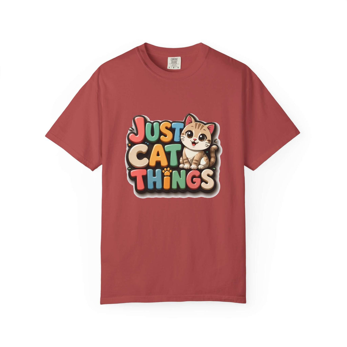 A red short-sleeve crewneck t-shirt featuring a colorful graphic on the chest that reads 'JUST CAT THINGS' in playful multicolored letters next to a cute cartoon kitten.