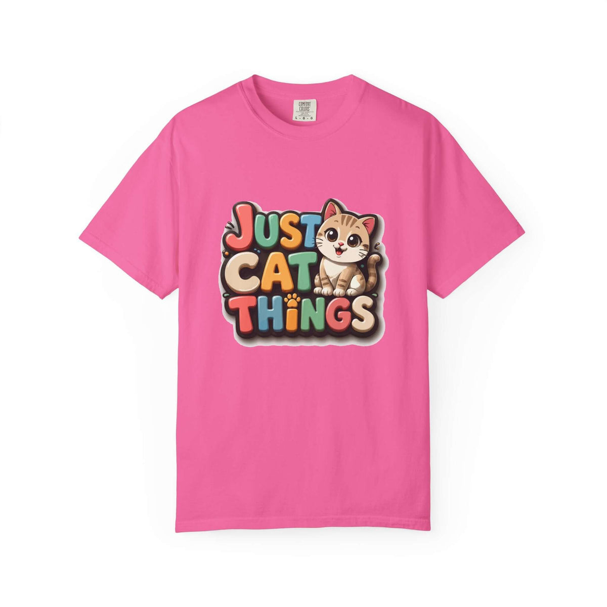 A bright pink short-sleeve t-shirt with a colorful graphic on the chest that reads 'JUST CAT THINGS' in a retro, multi-colored bubble font, accompanied by a cute cartoon kitten sitting on the lettering. The t-shirt is displayed flat against a clean white background.