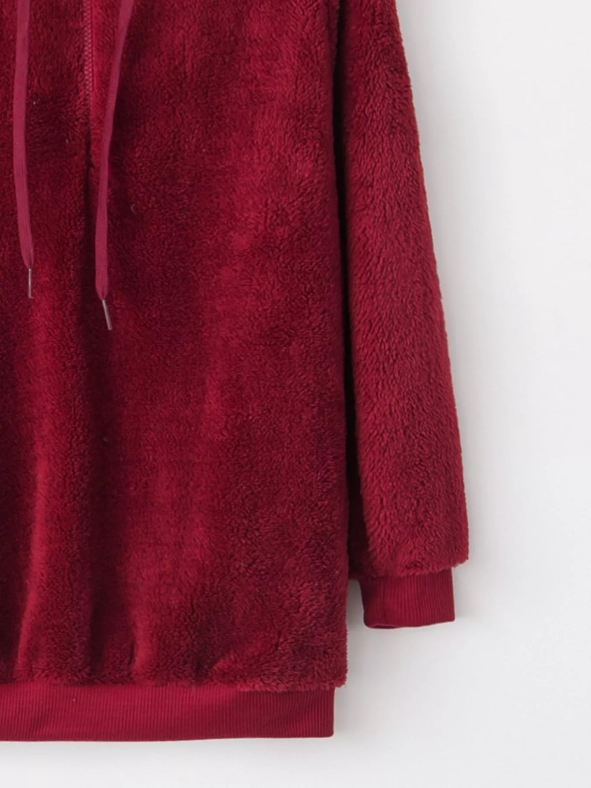 Close up of the high-quality front half zipper and thick adjustable hood drawstrings on CLOTHRA unisex fleece pullover. in a color Burgundy