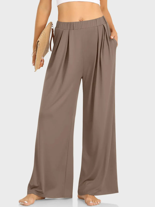 CLOTHRA minimalist elastic waist wide leg pants showing a relaxed baggy fluid drape in an authentic urban street look. in color Taupe