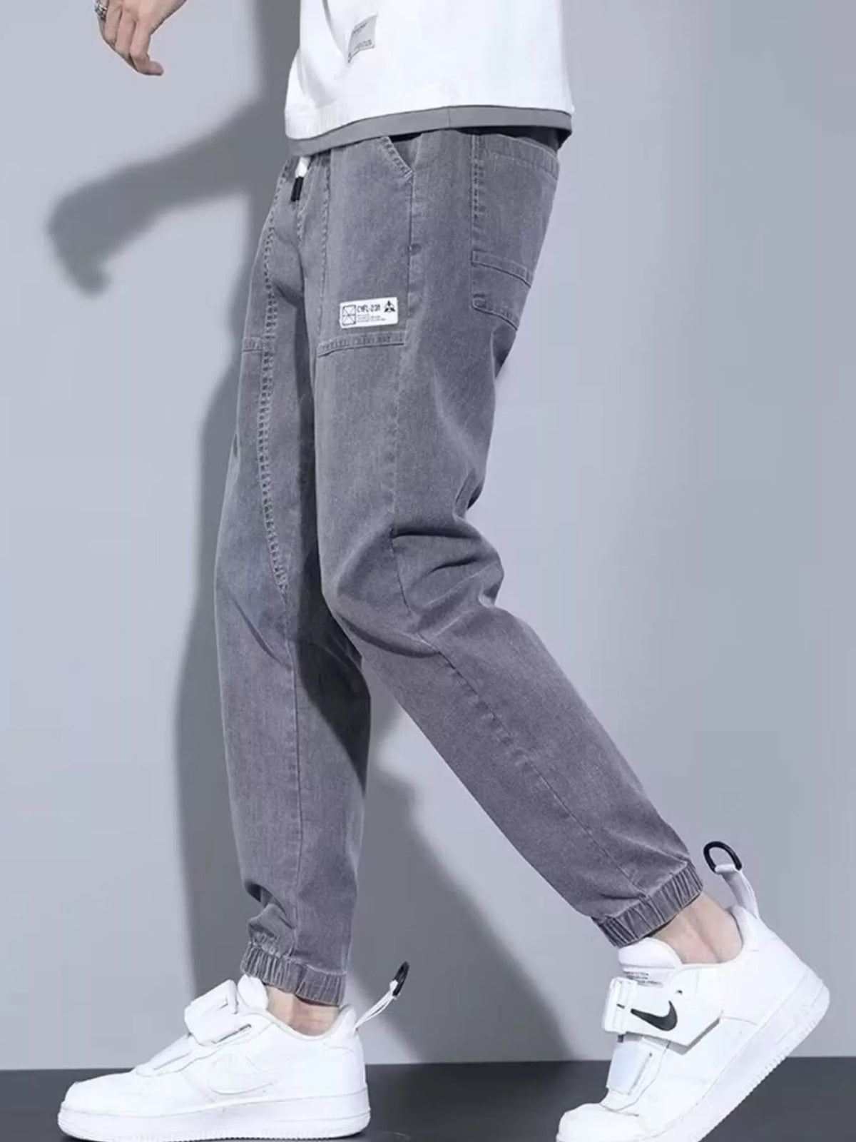 Close up shot of the soft elastic ankle cuffs and premium non see through polyester knit weave on CLOTHRA matching joggers. Side view