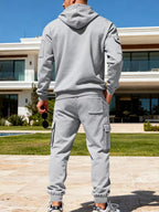 CLOTHRA men's plus size matching half zip hoodie and multi pocket cargo pants two piece utility tracksuit set in a clean urban look. in a Back side view Light Grey color