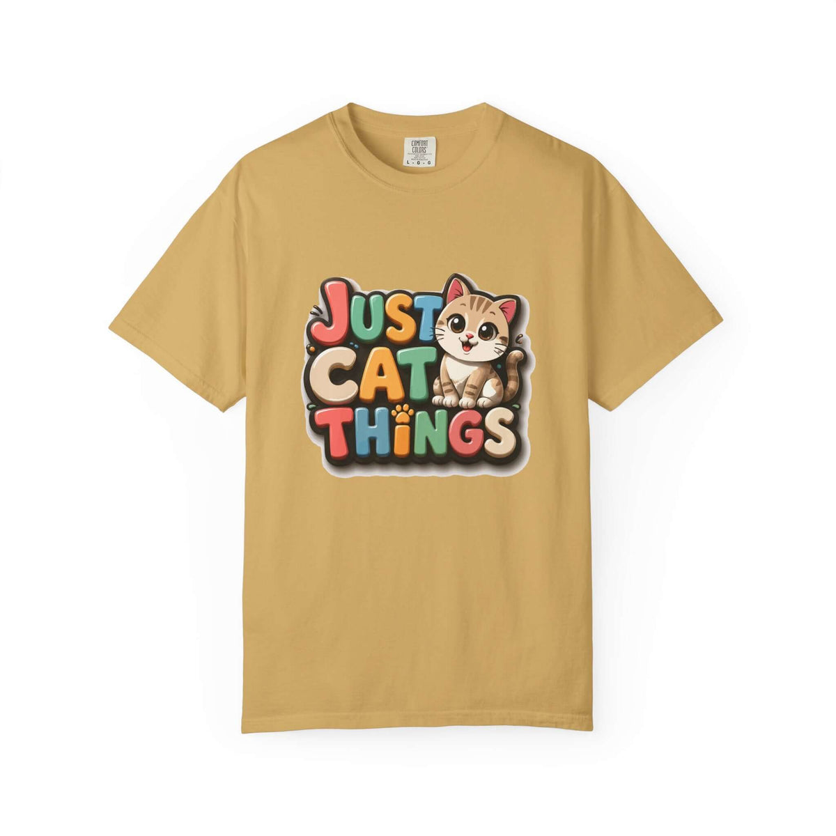 A tan short-sleeve crewneck t-shirt featuring a colorful graphic on the chest that reads 'JUST CAT THINGS' in a playful multicolor font, accompanied by a cute cartoon cat illustration.