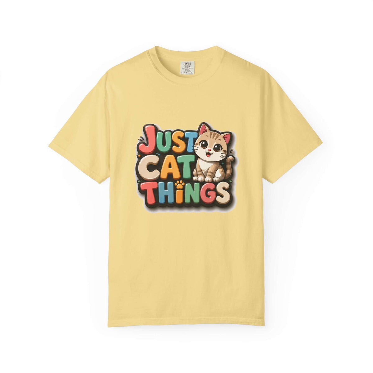 A pale yellow short-sleeve t-shirt with a colorful graphic on the chest that reads 'JUST CAT THINGS' alongside a cartoon kitten, shown against a plain white background.