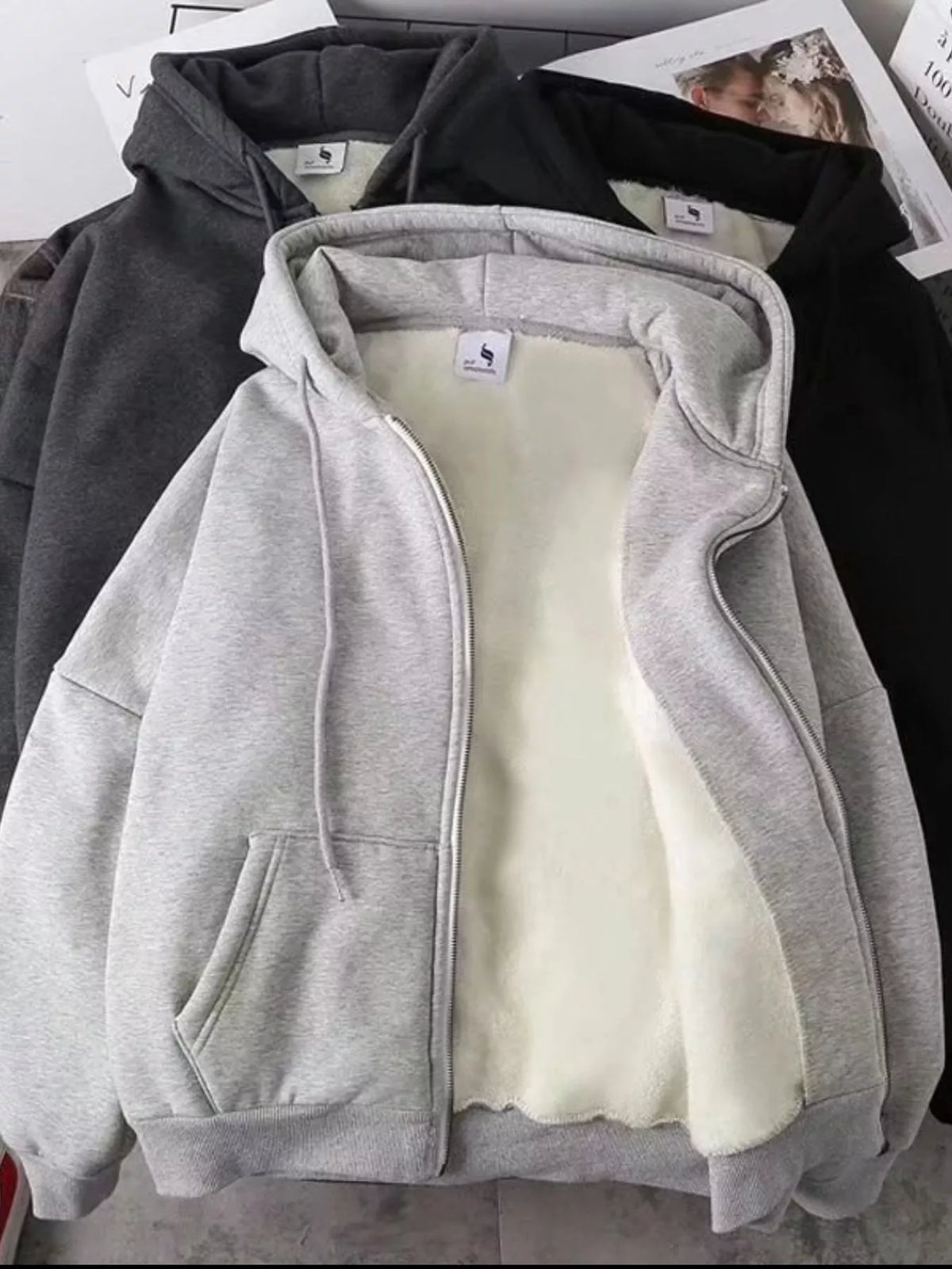 Close up of the warm plush fleece lining interior and smooth metal zipper track on CLOTHRA plus size unisex hoodie