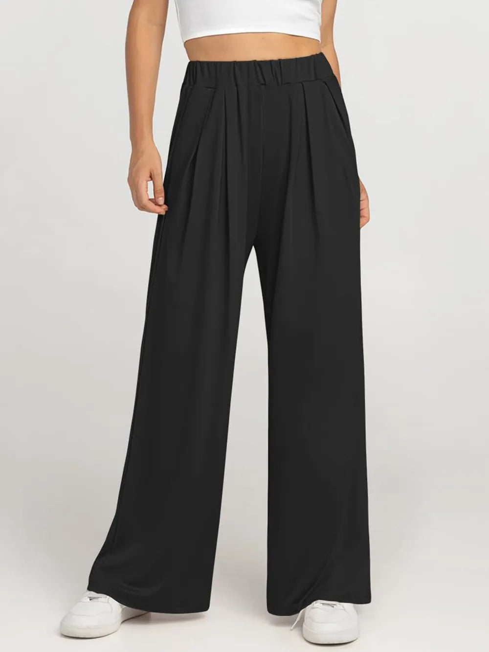CLOTHRA minimalist elastic waist wide leg pants showing a relaxed baggy fluid drape in an authentic urban street look. in a color Black