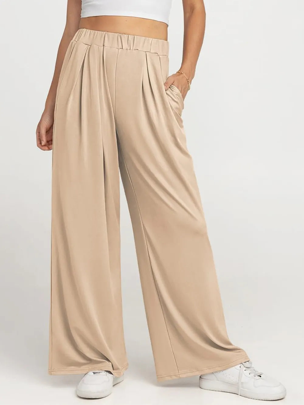 Close up of the secure flat lock stitching and flexible elastic waistband on CLOTHRA wide leg streetwear trousers. in a color Tan