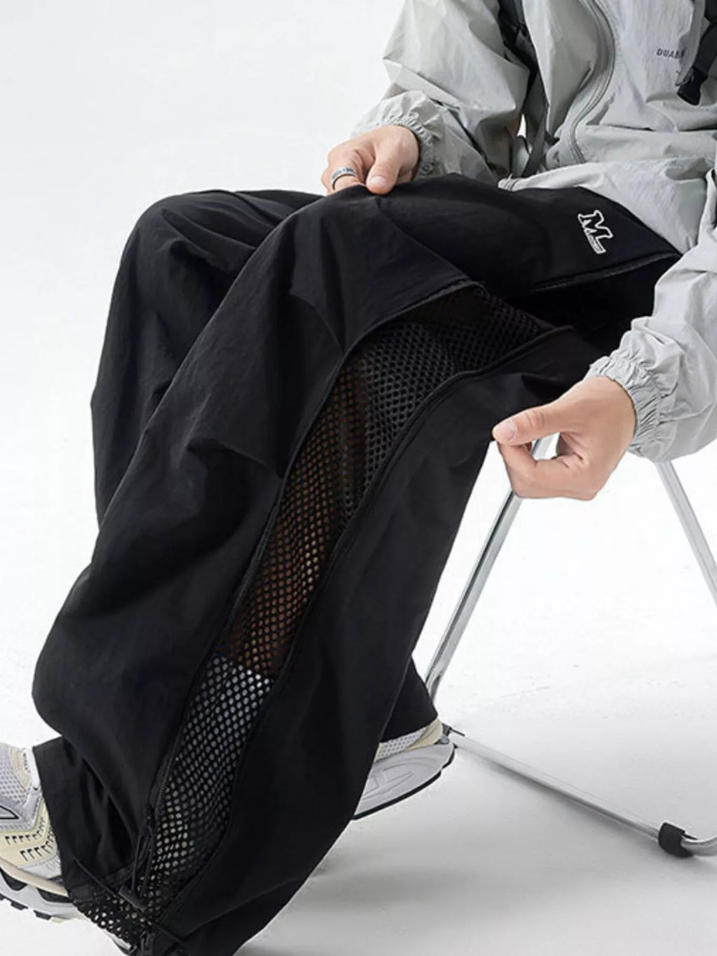 Close up of the wide non-roll elastic waistband and adjustable front drawstring on CLOTHRA men relaxed cargo pants.