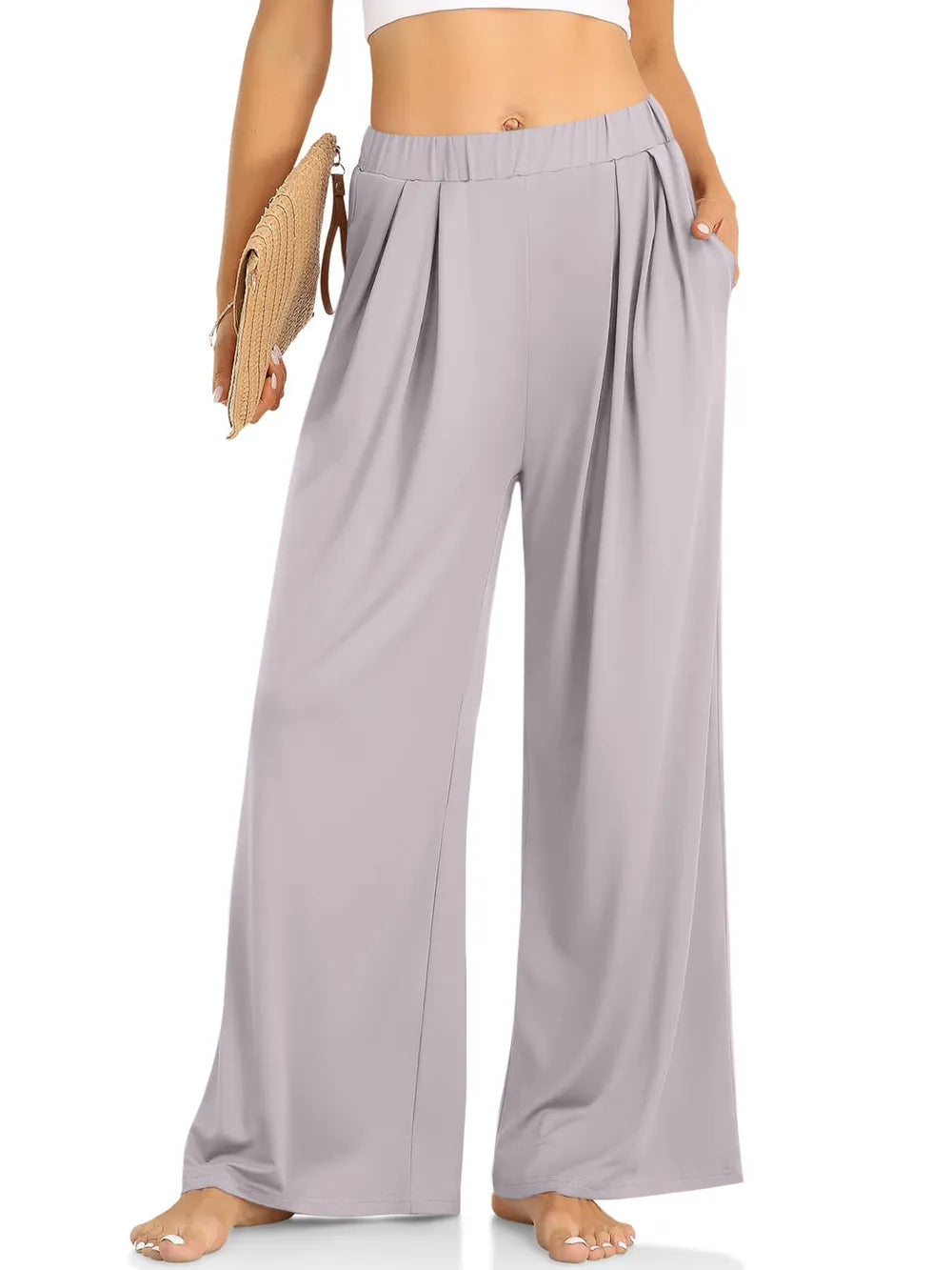 CLOTHRA minimalist elastic waist wide leg pants showing a relaxed baggy fluid drape in an authentic urban street look. in a color Light Grey