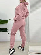 CLOTHRA matching long sleeve pullover hoodie and tapered joggers two piece lounge set in a clean minimalist street look. Side View