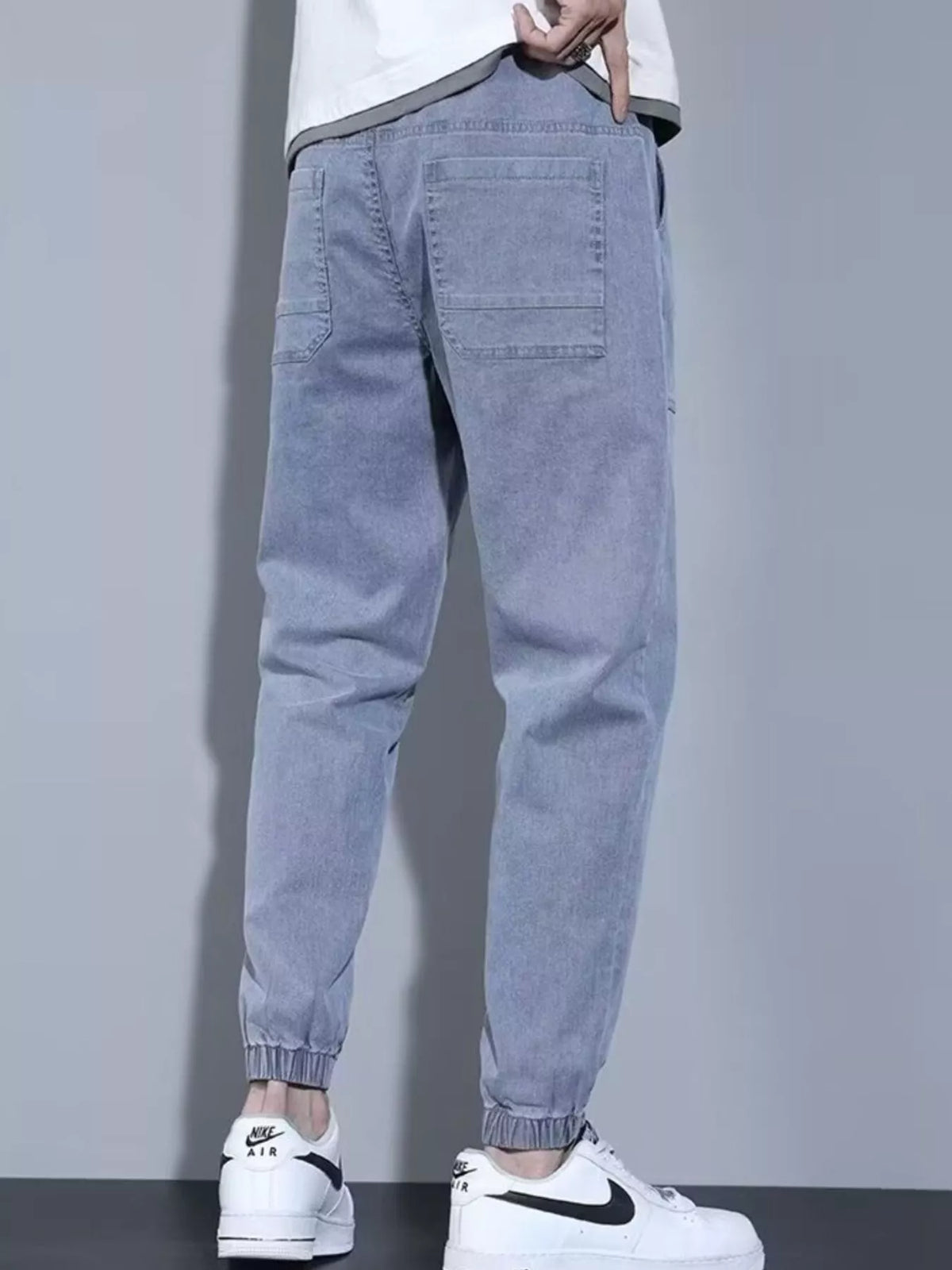 Close up shot of the soft elastic ankle cuffs and premium non see through polyester knit weave on CLOTHRA matching joggers. Back side view