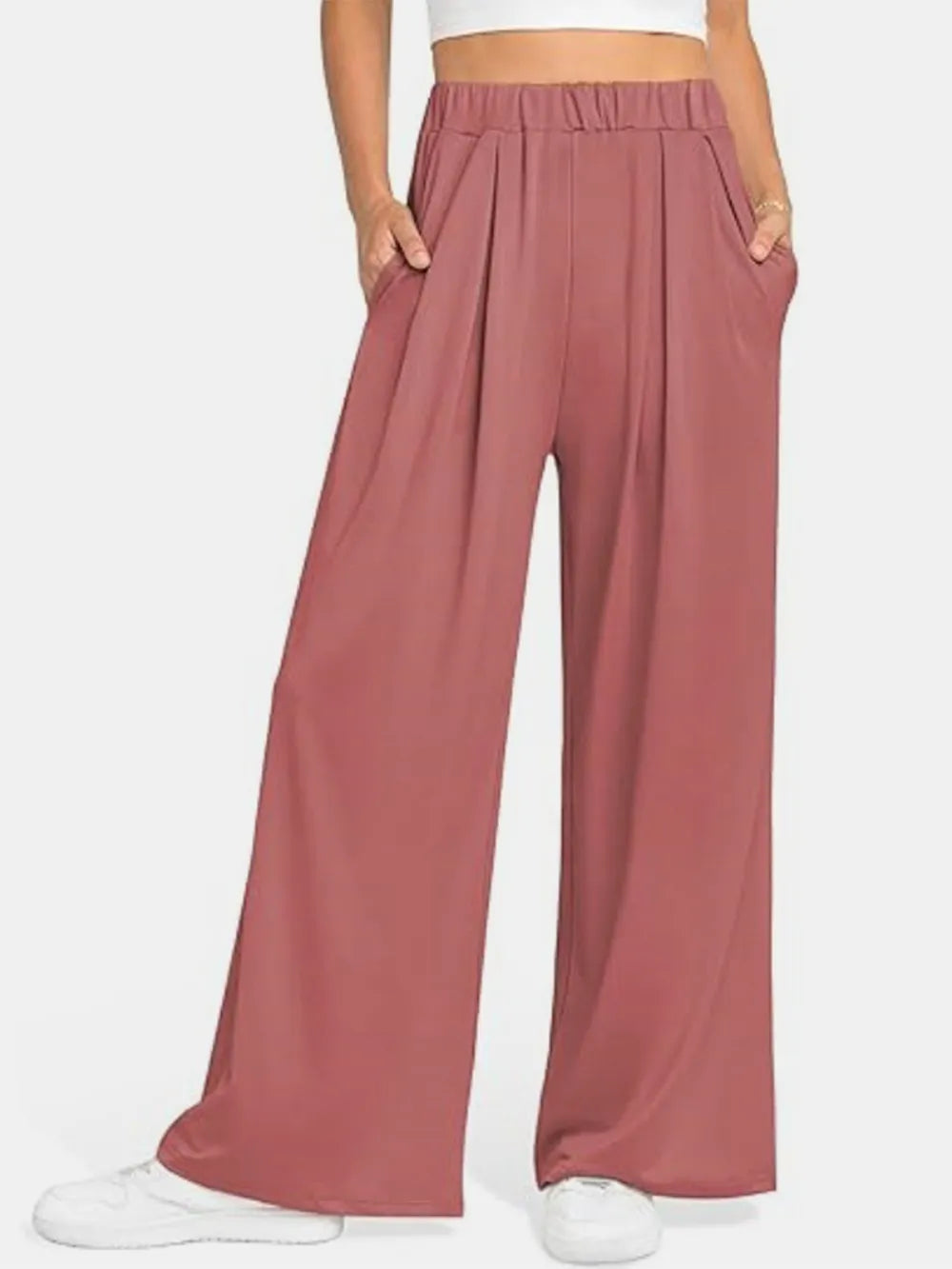 CLOTHRA minimalist elastic waist wide leg pants showing a relaxed baggy fluid drape in an authentic urban street look. in a color Burnt Coral
