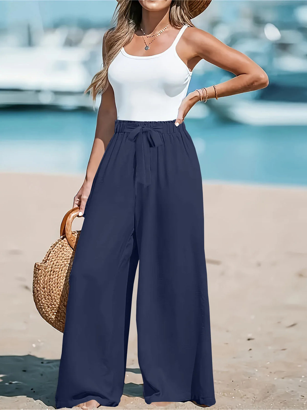 Close up of the adjustable front tied drawstring cords and secure wide flat waistband on CLOTHRA plus size trousers. in a color Nav Blue