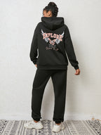 CLOTHRA matching drop shoulder graphic hoodie and cuffed sweatpants two piece streetwear tracksuit set in an oversized urban look. Back side view