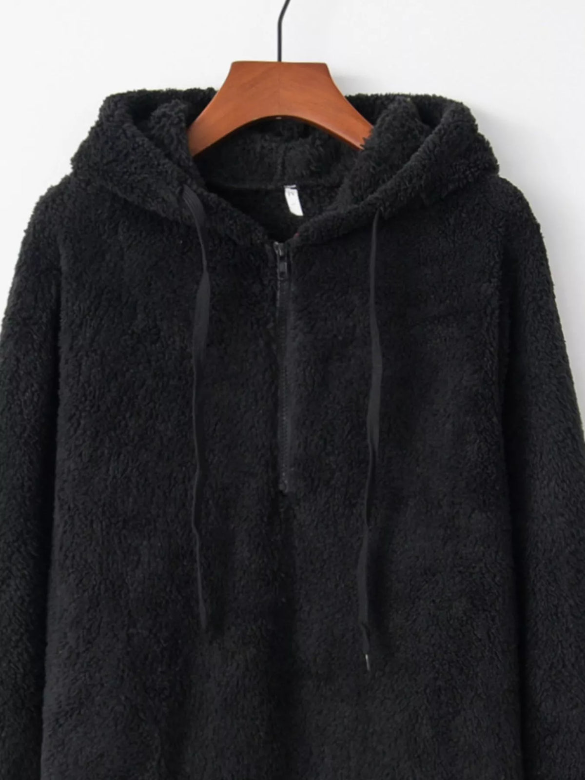 Detailed close up of the deep side hand pockets and ultra-soft woven fleece fabric texture on CLOTHRA unisex outerwear. in a color Black
