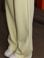 Close up shot of the secure side pocketing, flexible elastic waistband, and cuffed ankles on CLOTHRA matching lounge sweatpants.