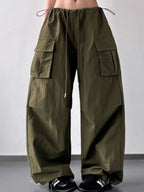 Model styling the oversized wide leg drape of CLOTHRA cargo pants with a streetwear hoodie.