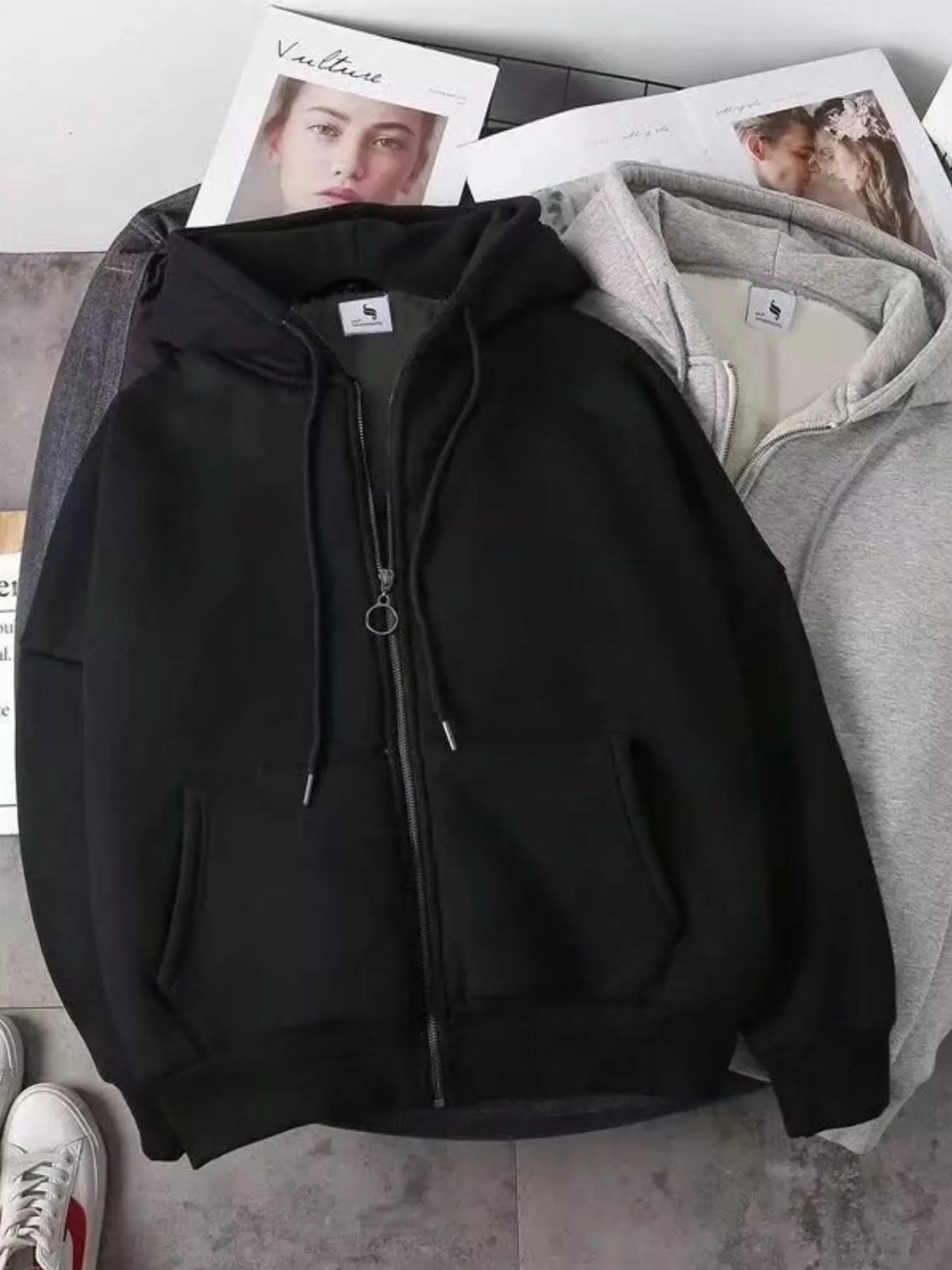 Close up of the warm plush fleece lining interior and smooth metal zipper track on CLOTHRA plus size unisex hoodie in a color Black