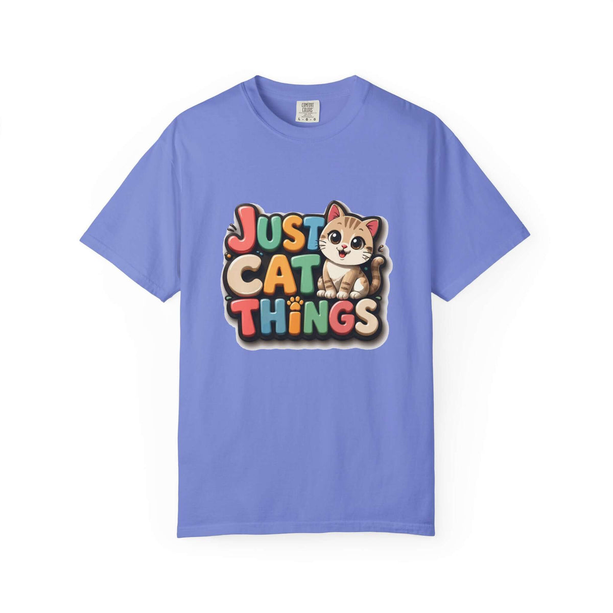 A light blue short-sleeve crewneck t-shirt featuring a colorful graphic on the chest that reads 'JUST CAT THINGS' in playful multicolored letters next to a cute cartoon cat.