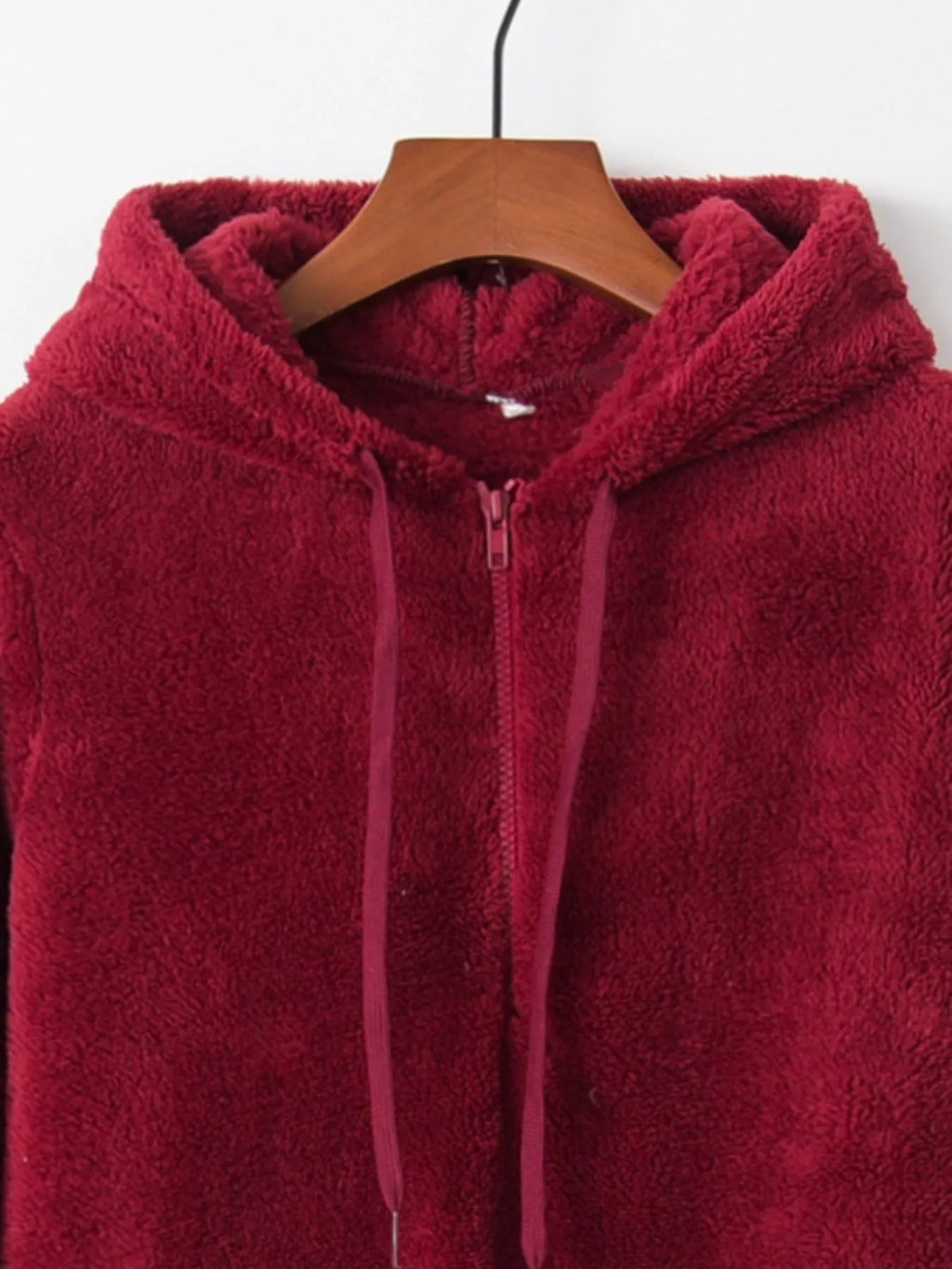 Detailed close up of the deep side hand pockets and ultra-soft woven fleece fabric texture on CLOTHRA unisex outerwear. in a color Burgundy