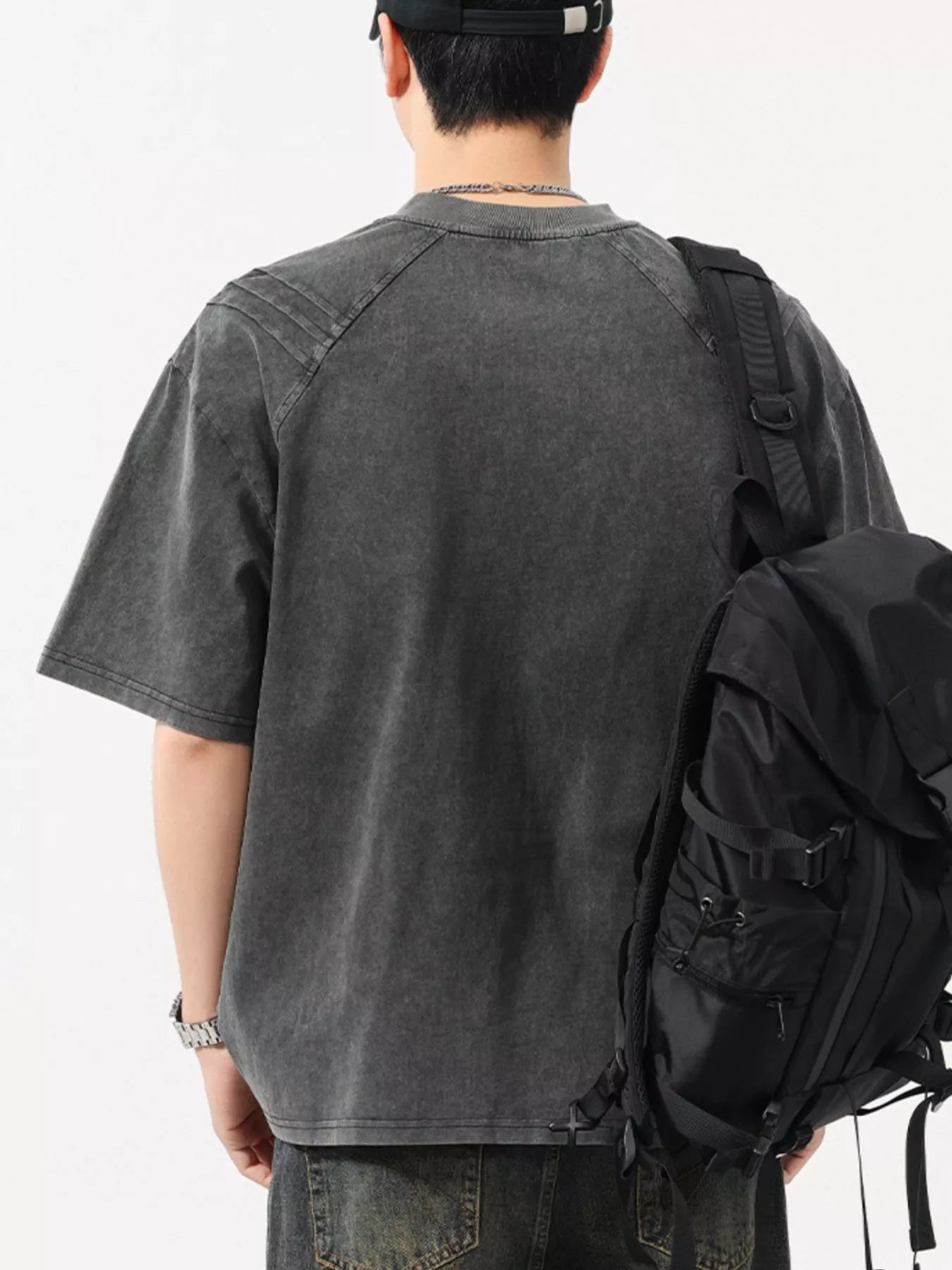 Close up shot of the soft pigment washed cotton spandex fabric showing its slight stretch flexibility on CLOTHRA matching shirt. in a color Dark Grey back side view