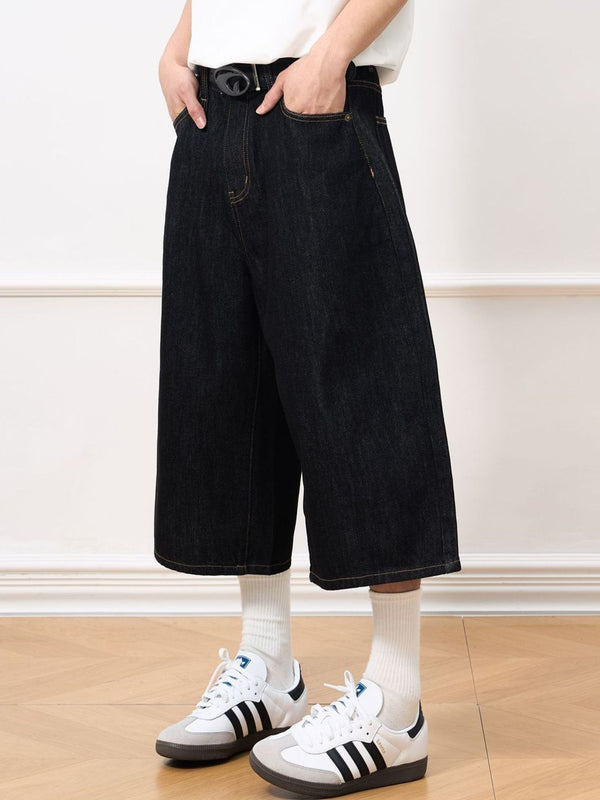 Close up of the durable belt loops, secure button closure, and front pockets on CLOTHRA men stretch jean shorts.