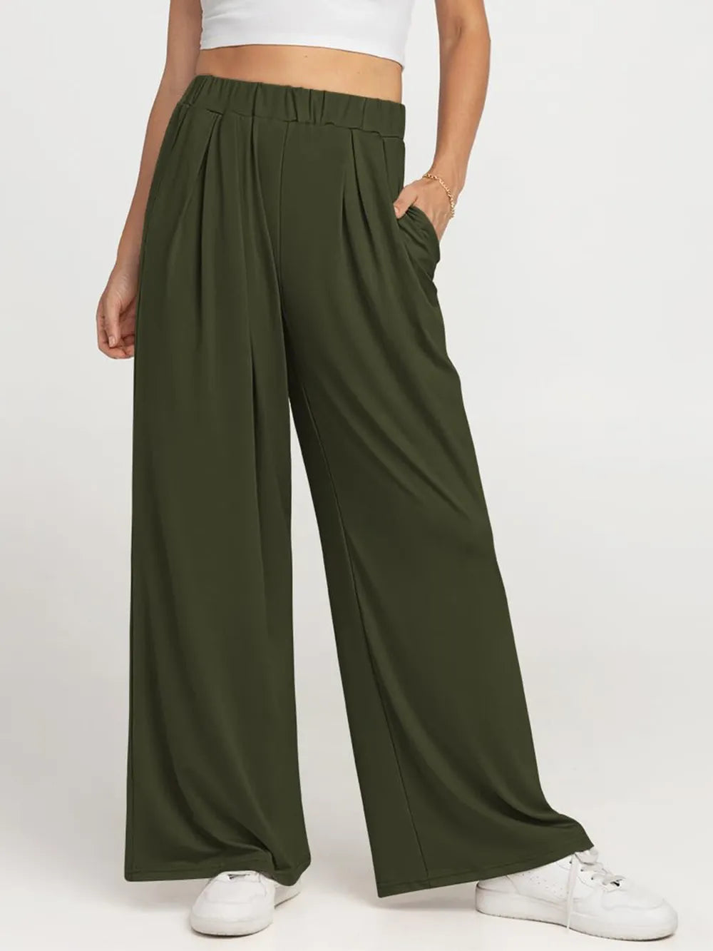 CLOTHRA minimalist elastic waist wide leg pants showing a relaxed baggy fluid drape in an authentic urban street look. in a color Army Green