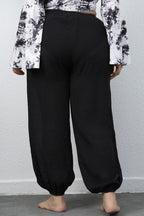 Close up shot of the adjustable tied drawstring waistband on CLOTHRA plus size jogger pants. Back side