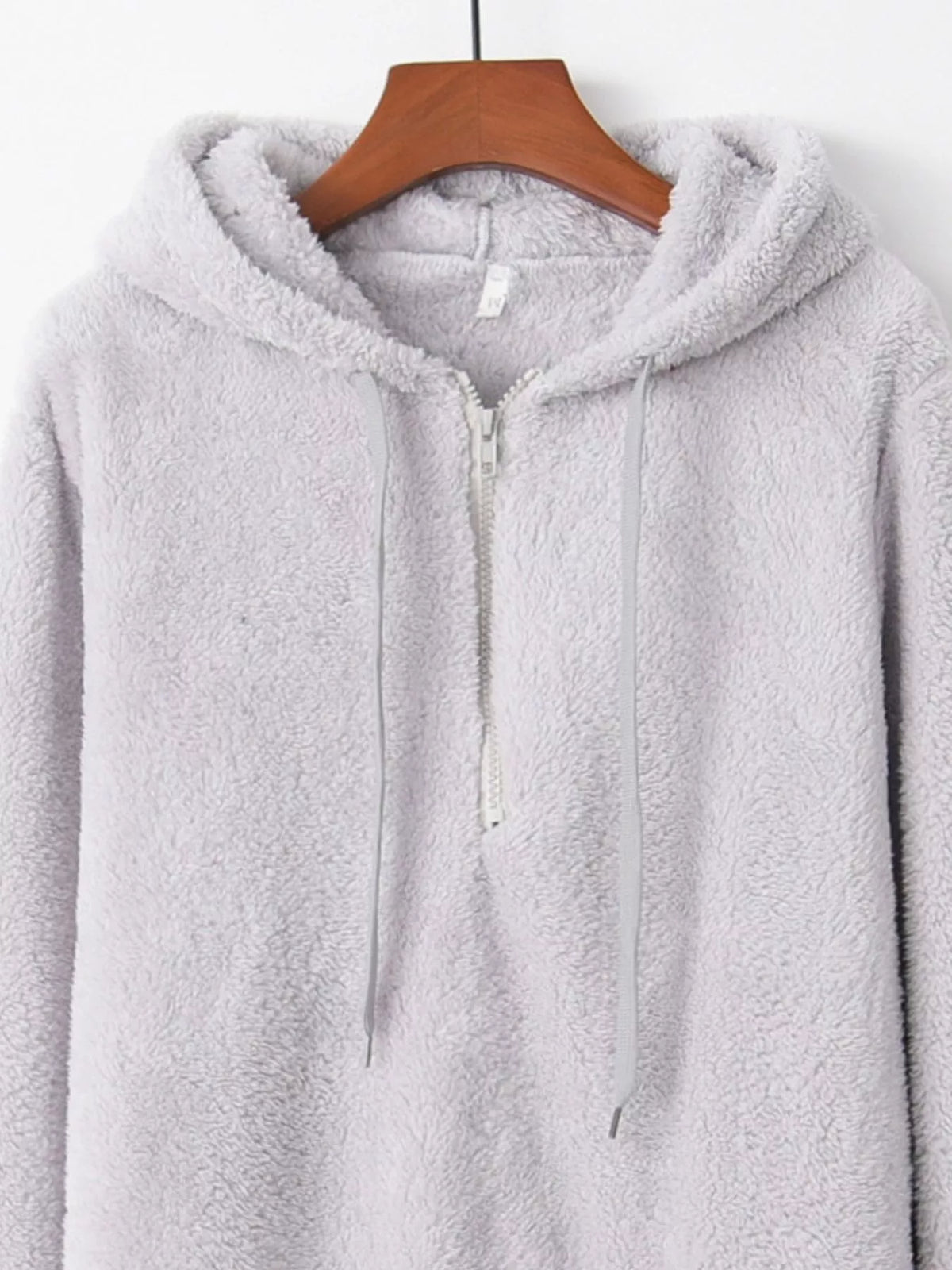 Detailed close up of the deep side hand pockets and ultra-soft woven fleece fabric texture on CLOTHRA unisex outerwear. in a color Light Grey