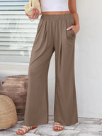 Close up of the secure flat lock stitching and flexible elastic waistband on CLOTHRA wide leg streetwear trousers.
