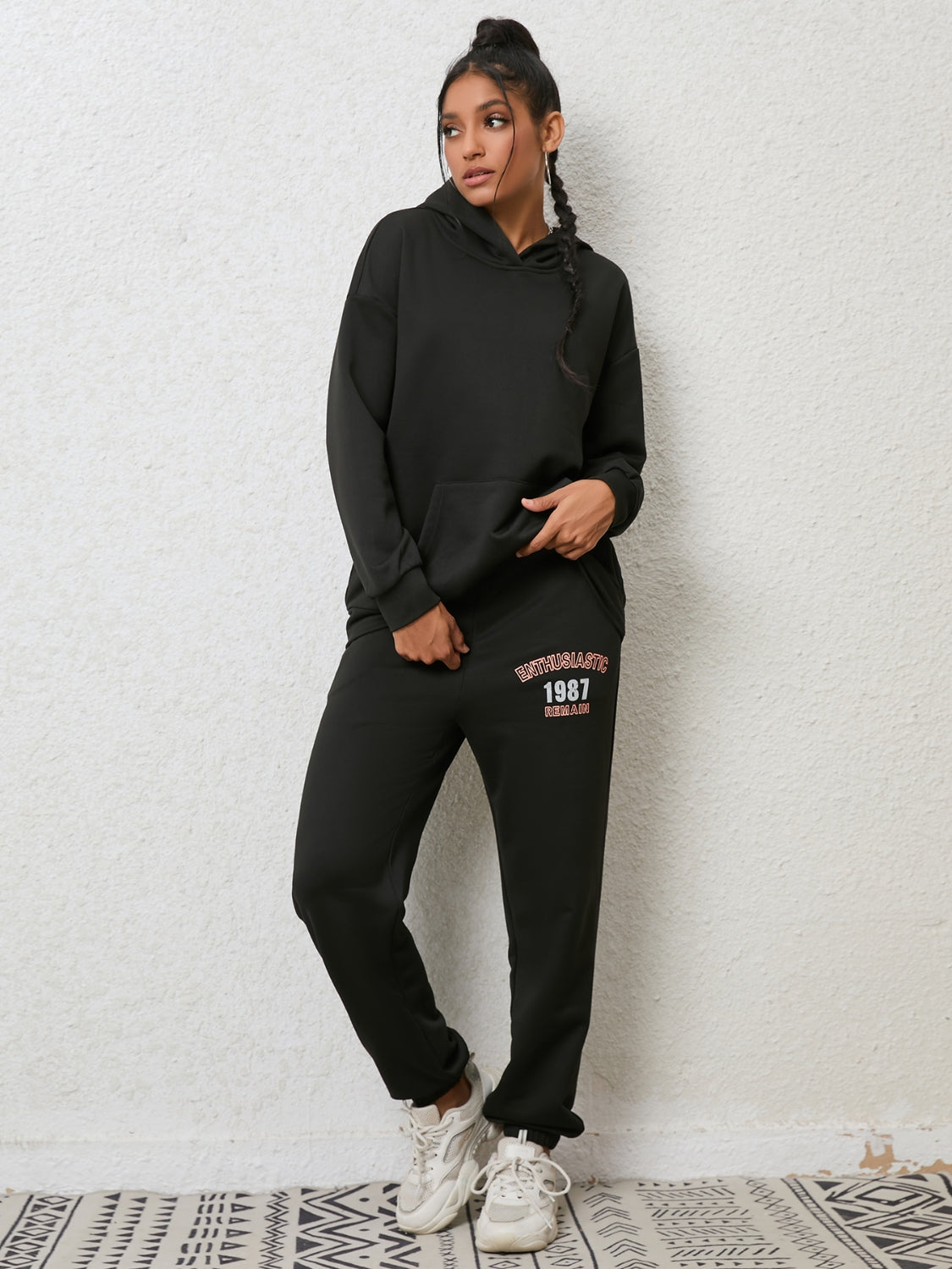 CLOTHRA matching drop shoulder graphic hoodie and cuffed sweatpants two piece streetwear tracksuit set in an oversized urban look. Close-up