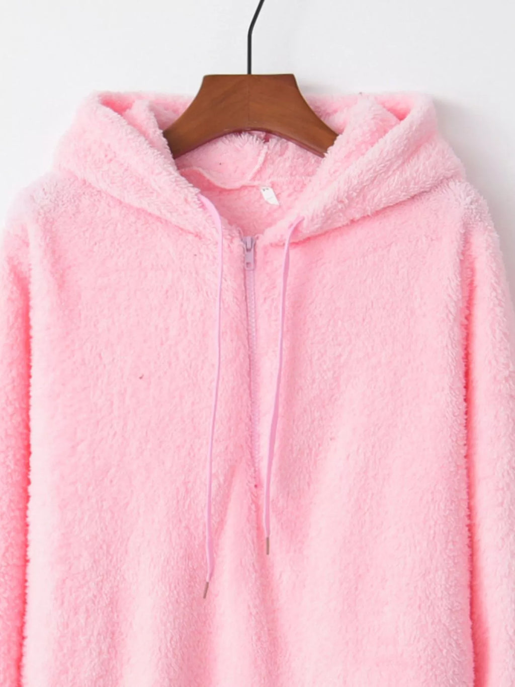 Detailed close up of the deep side hand pockets and ultra-soft woven fleece fabric texture on CLOTHRA unisex outerwear. in a color Pink