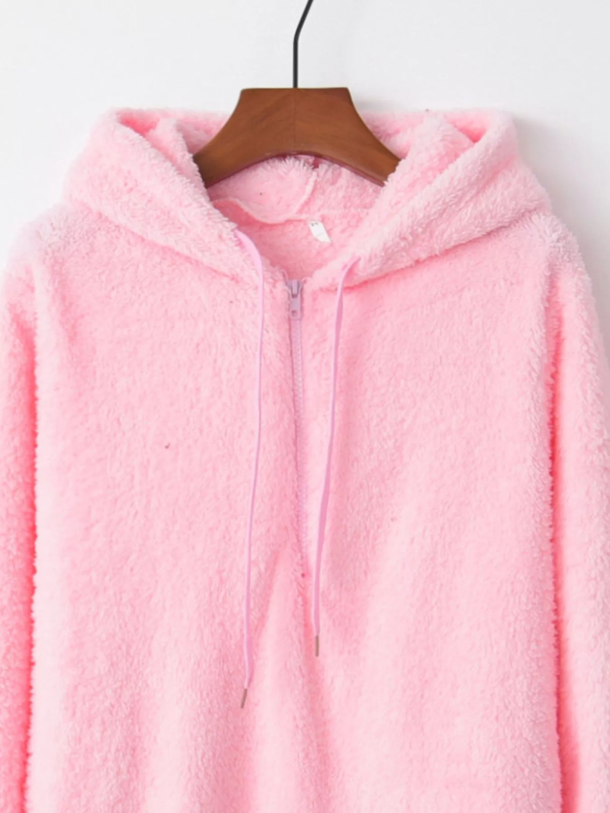 Detailed close up of the deep side hand pockets and ultra-soft woven fleece fabric texture on CLOTHRA unisex outerwear. in a color Pink