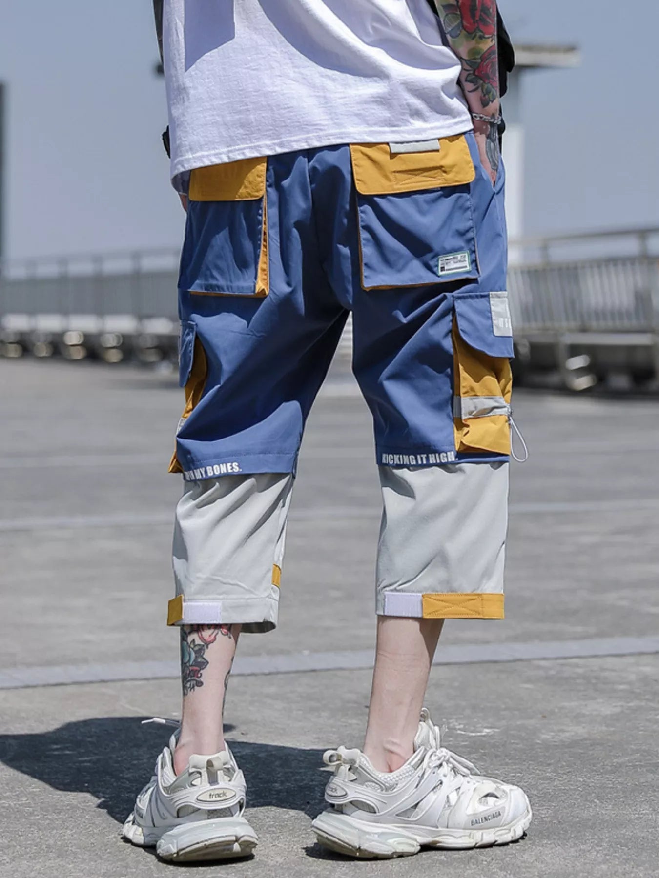 CLOTHRA men plus size color block cargo pants showing a modern contrast panel streetwear look with multi pockets. back side view