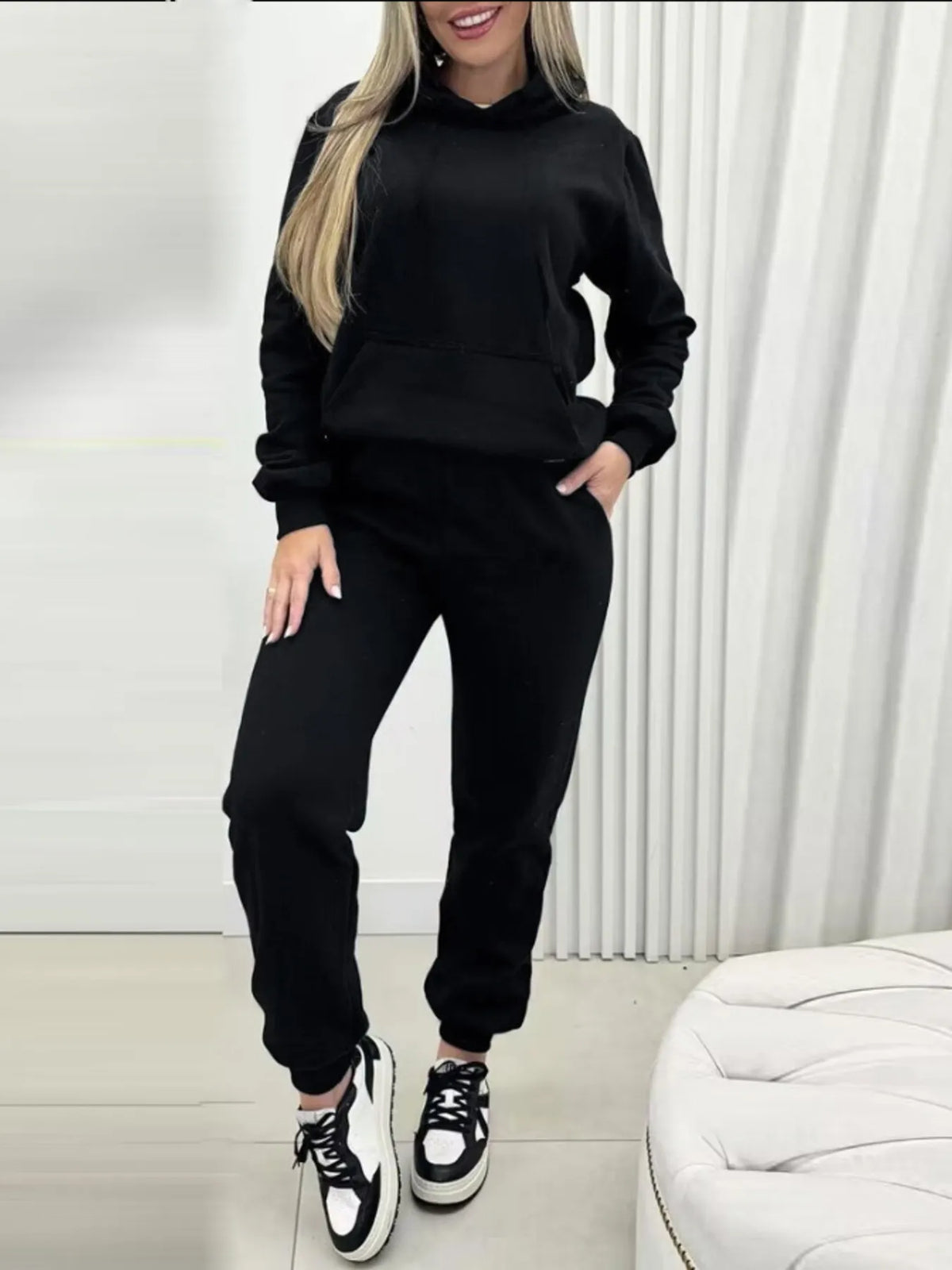 CLOTHRA matching long sleeve pullover hoodie and tapered joggers two piece lounge set in a clean minimalist street look. Full view Black