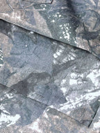 Close up shot of the heavy duty side cargo flap pockets and premium stretch fabric texture on CLOTHRA matching pants.
