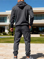CLOTHRA men's plus size matching half zip hoodie and multi pocket cargo pants two piece utility tracksuit set in a clean urban look. Back side view in Dark Grey color