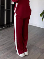 Close up shot of the secure stitching, premium fabric texture, and flexible stretch waistband on CLOTHRA matching pants. in a color Burgundy