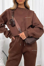 CLOTHRA matching round neck sweatshirt and cuffed joggers two piece lounge tracksuit set in a clean minimalist street look. Close-up