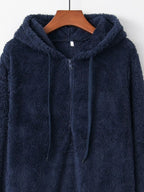 Detailed close up of the deep side hand pockets and ultra-soft woven fleece fabric texture on CLOTHRA unisex outerwear. in a color Blue