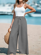 Close up of the adjustable front tied drawstring cords and secure wide flat waistband on CLOTHRA plus size trousers. in a color Grey