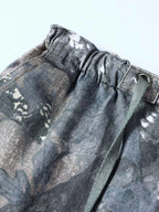 Close up of the adjustable drawstring cords and secure wide elastic waistband on CLOTHRA camo utility trousers.