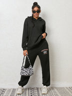 CLOTHRA matching drop shoulder graphic hoodie and cuffed sweatpants two piece streetwear tracksuit set in an oversized urban look.
